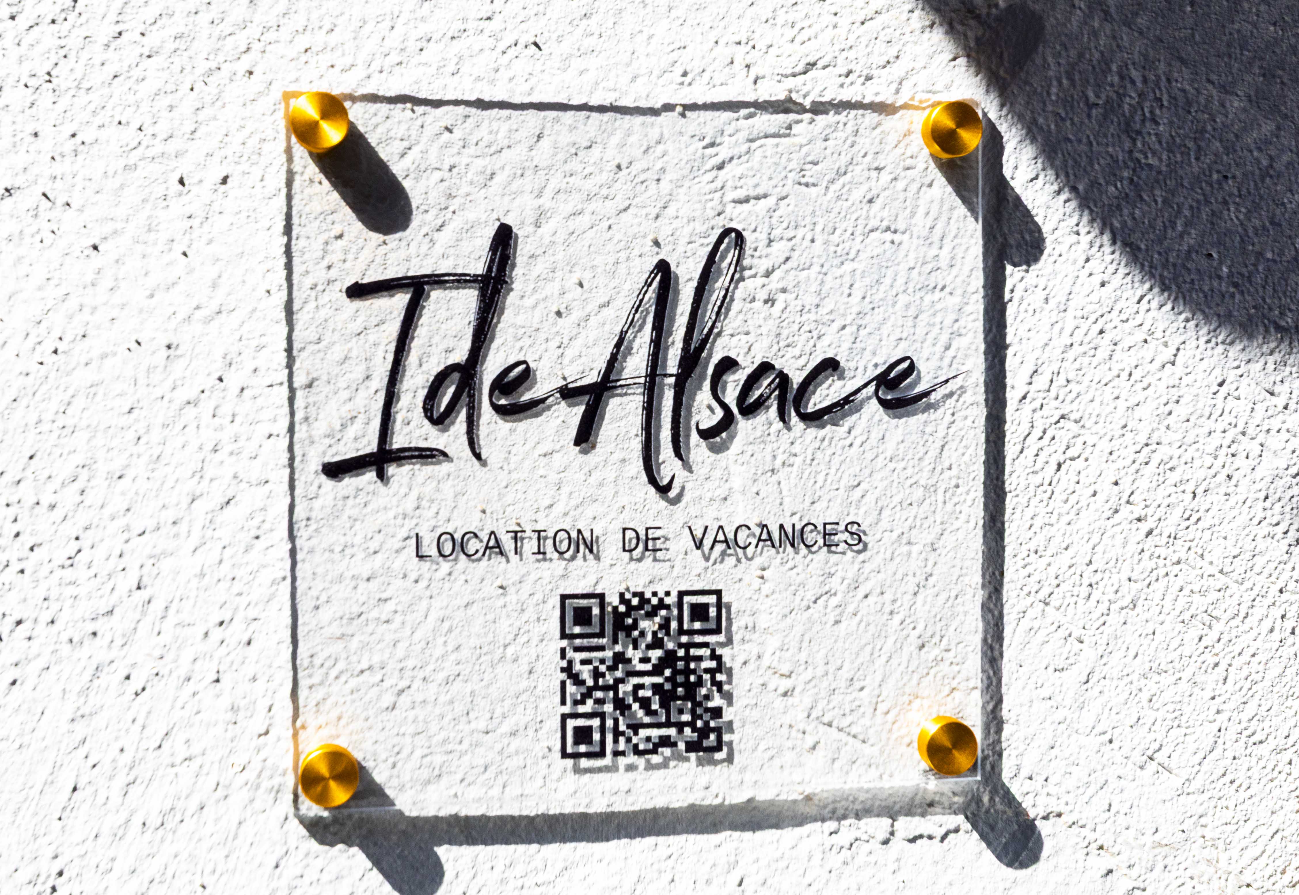 Plaque « Ide Alsace, location de vacances » à l'entrée de la maison